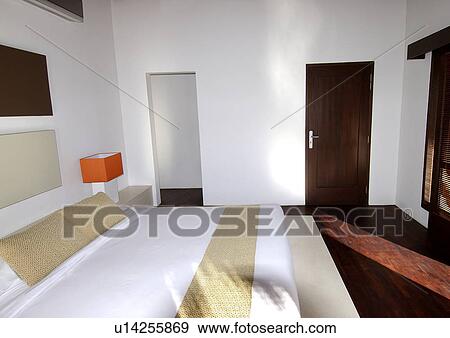 Stock Photo - Double bed in a bedroom. Fotosearch