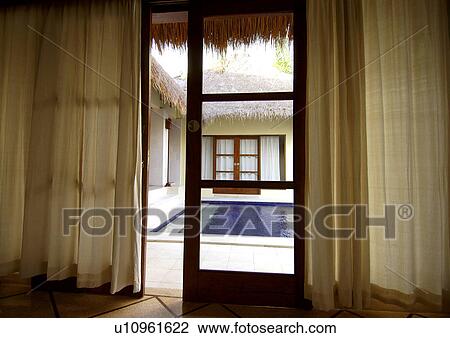Open door leading to a swimming pool View Large Photo Image Stock Image - Open door leading to a swimming pool. Fotosearch