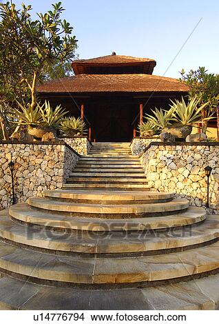 View of a staircase leading to the entrance of a shade in a resort. View Large Photo Image Picture - View of a staircase leading to the entrance of a shade in a resort.. Fotosearch