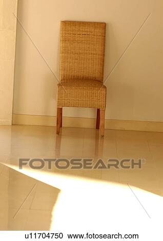 Wicker chair near a wall View Large Photo Image Stock Image - Wicker chair near a wall. Fotosearch