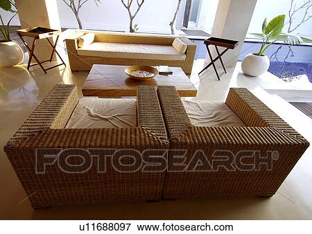 Stock Photo - Wicker couch in a room. Fotosearch