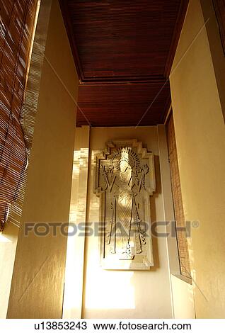 Stock Image - Carved stone artifact on a wall. Fotosearch