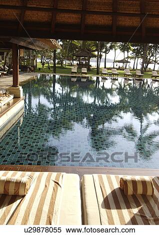 Towels and linen are arranged by a pool. View Large Photo Image Stock Photography - Towels and linen are arranged by a pool.. Fotosearch