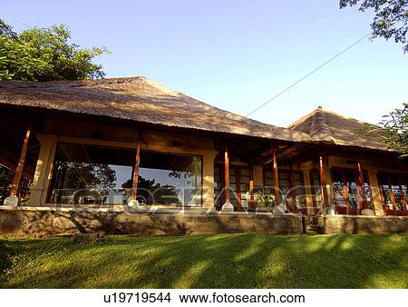 Picture - View of a building covered with thatch.. Fotosearch