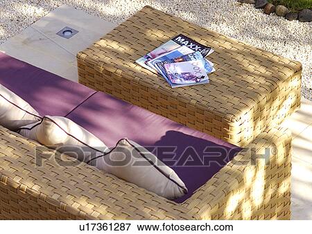 Stock Photo - View of a comfortable cane couch and a table.. Fotosearch