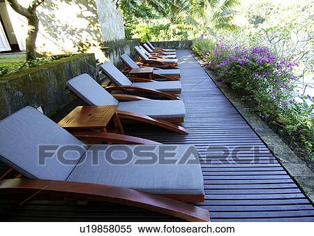 View of a row of deck chairs in a resort, Mayaubud. View Large Photo Image Stock Photography - View of a row of deck chairs in a resort, Mayaubud.. Fotosearch