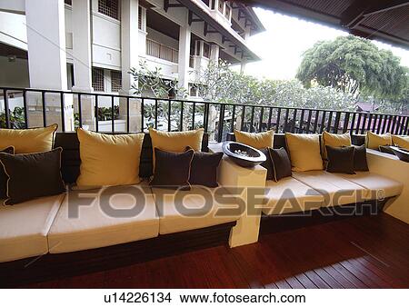 View of lounges with cushions in a lanai. View Large Photo Image Picture - View of lounges with cushions in a lanai.. Fotosearch