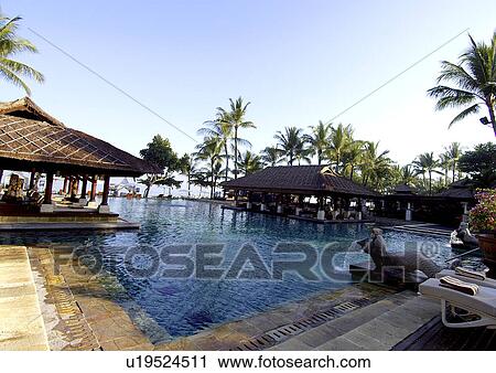 View of shades by the swimming pool in a resort. View Large Photo Image Stock Image - View of shades by the swimming pool in a resort.. Fotosearch