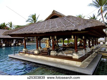 View of shades by the swimming pool in a resort. View Large Photo Image Stock Photo - View of shades by the swimming pool in a resort.. Fotosearch