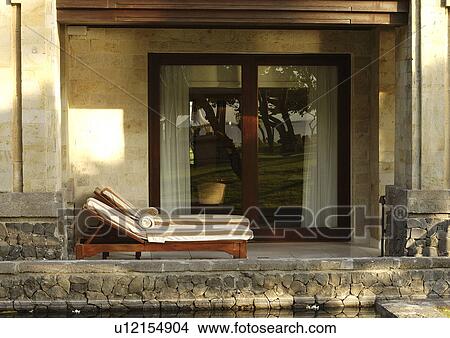 View of two deck chairs along a poolside. View Large Photo Image Picture - View of two deck chairs along a poolside.. Fotosearch