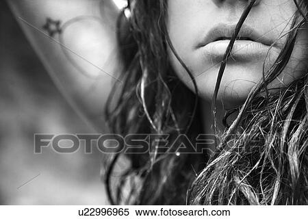 Stock Photography - Young adult female face and disheveled hair. Fotosearch