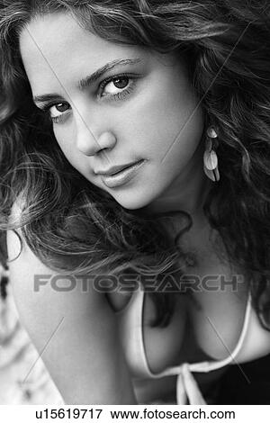 Young adult woman with hair blowing looking at viewer View Large Photo Image Stock Photo - Young adult woman with hair blowing looking at viewer. Fotosearch