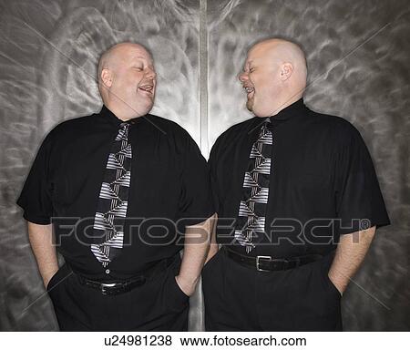 Bald identical twin men looking at each other and laughing View Large Photo Image Stock Photo - Bald identical twin men looking at each other and laughing. Fotosearch