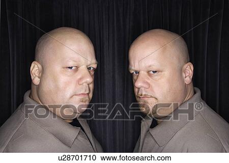 Bald identical twin men looking sternly View Large Photo Image Stock Image - Bald identical twin men looking sternly. Fotosearch