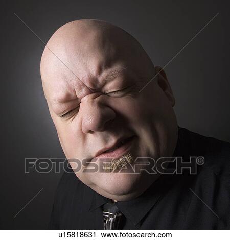 Bald man squinting and making facial expression View Large Photo Image Stock Image - Bald man squinting and making facial expression. Fotosearch