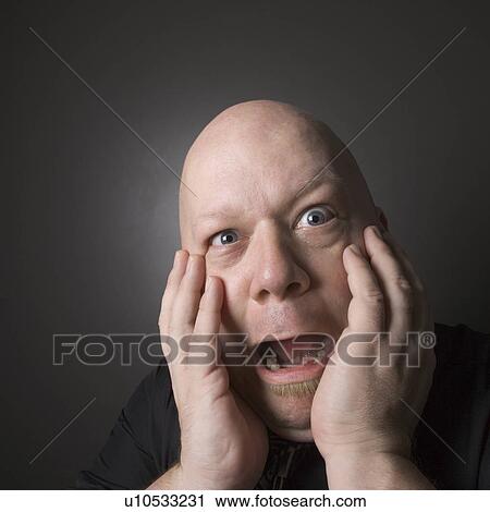 Bald man with hands to face making scared facial expression View Large Photo Image Stock Image - Bald man with hands to face making scared facial expression. Fotosearch