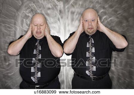 Bald mid adult identical twin men standing with hands covering ears making facial expression. View Large Photo Image Stock Photo - Bald mid adult identical twin men standing with hands covering ears making facial expression.. Fotosearch