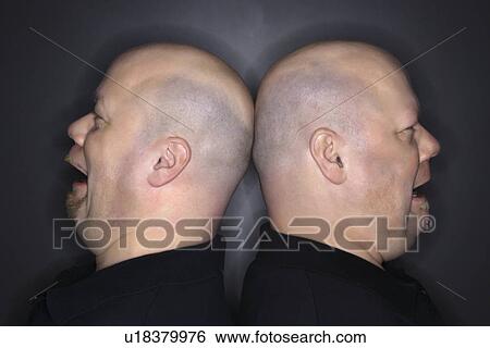 Bald mid adult identical twin men standing back to back with sad expressions. View Large Photo Image Stock Photograph - Bald mid adult identical twin men standing back to back with sad expressions.. Fotosearch