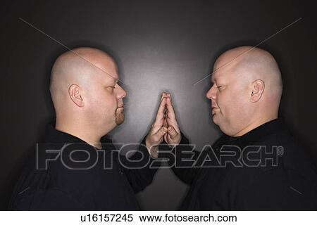 Bald mid adult identical twin men standing face to face with hands touching. View Large Photo Image Stock Photography - Bald mid adult identical twin men standing face to face with hands touching.. Fotosearch