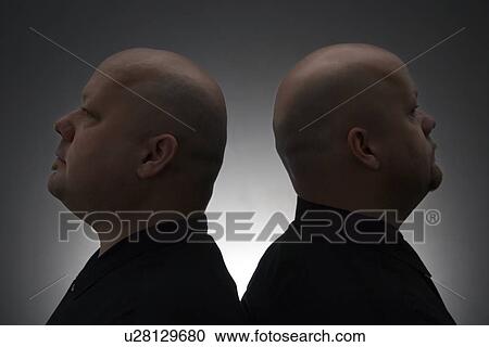 Mid adult bald identical twin men standing back to back. View Large Photo Image Stock Image - Mid adult bald identical twin men standing back to back.. Fotosearch