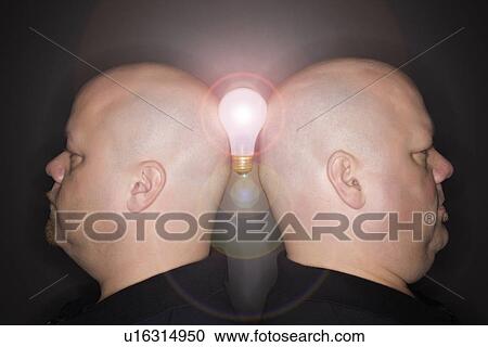 Mid adult identical twin men standing back to back and balancing a light bulb between them. View Large Photo Image Stock Image - Mid adult identical twin men standing back to back and balancing a light bulb between them.. Fotosearch