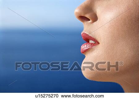 Stock Image - Close up portrait of woman's face with Pacific Ocean in background . Fotosearch