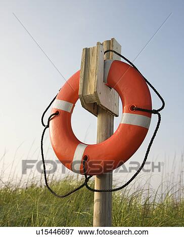 Life preserver hanging on post on beach on Bald Head Island, North Carolina View Large Photo Image Stock Photo - Life preserver hanging on post on beach on Bald Head Island, North Carolina. Fotosearch