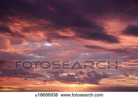 Purple glowing clouds during sunset View Large Photo Image Stock Photo - Purple glowing clouds during sunset . Fotosearch