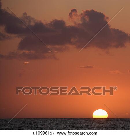Sun setting over horizon of ocean. View Large Photo Image Stock Photo - Sun setting over horizon of ocean.. Fotosearch