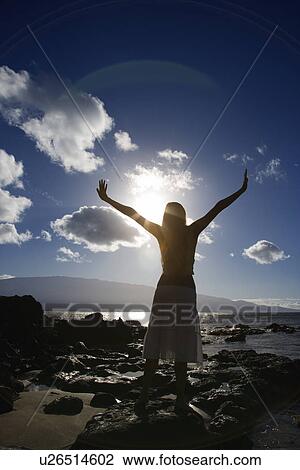 Young adult Asian Filipino female stretching arms in air on beach View Large Photo Image Stock Image - Young adult Asian Filipino female stretching arms in air on beach . Fotosearch