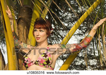 Woman in bikini with palm tree View Large Photo Image Stock Photograph - Woman in bikini with palm tree . Fotosearch