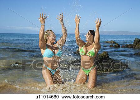 Stock Image - Women bodybuilders on beach. Fotosearch