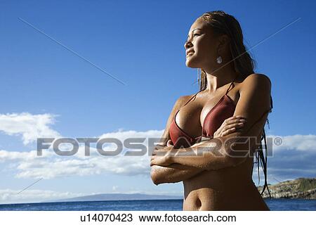 Stock Image - Young adult Asian Filipino in bikini on beach . Fotosearch