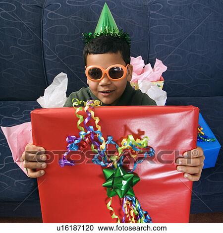 Stock Image - Boy wearing party hat and sunglasses . Fotosearch
