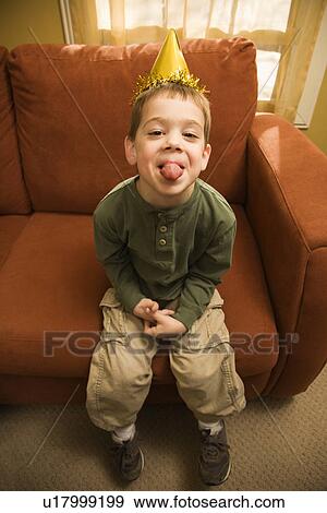 Stock Photo - Boy with party hat . Fotosearch