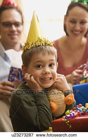 Caucasian boy at birthday party looking at viewer making facial expression. View Large Photo Image Stock Photo - Caucasian boy at birthday party looking at viewer making facial expression.. Fotosearch