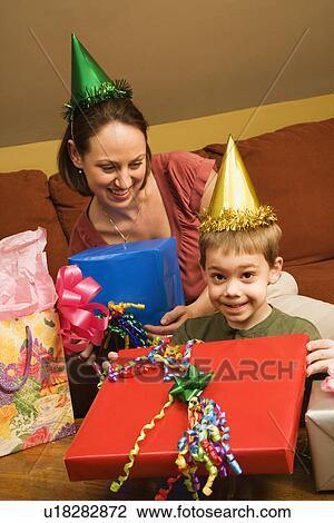Stock Image - Mother and son celebrating a birthday party. Fotosearch