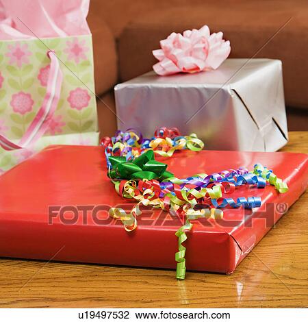 Presents wrapped and decorated with bows on a table. View Large Photo Image Stock Image - Presents wrapped and decorated with bows on a table.. Fotosearch