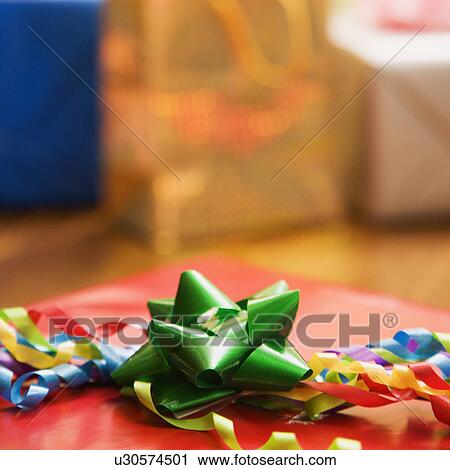 Presents wrapped and decorated with bows on a table. View Large Photo Image Stock Image - Presents wrapped and decorated with bows on a table.. Fotosearch