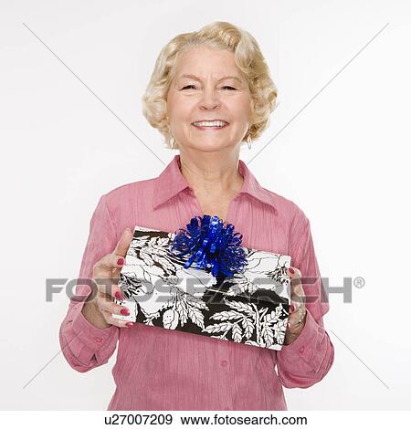 Stock Photo - Woman holding present. Fotosearch