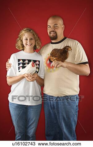 Caucasian mid-adult man and woman holding chickens. View Large Photo Image Stock Image - Caucasian mid-adult man and woman holding chickens.. Fotosearch