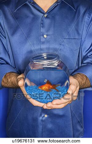 Male holding goldfish in bowl View Large Photo Image Stock Image - Male holding goldfish in bowl. Fotosearch