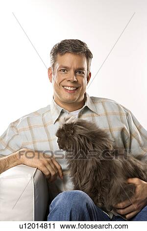 Mid-adult Caucasian man sitting holding Persian cat. View Large Photo Image Stock Image - Mid-adult Caucasian man sitting holding Persian cat.. Fotosearch