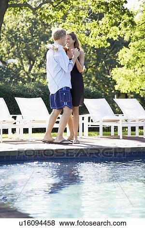 Couple dancing by pool View Large Photo Image Stock Photo - Couple dancing by pool. Fotosearch