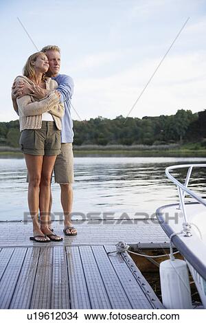 Picture - Couple hugging on pier. Fotosearch
