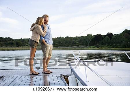 Couple standing on pier View Large Photo Image Stock Photo - Couple standing on pier. Fotosearch