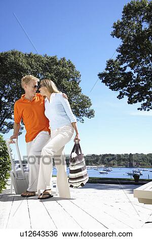 Couple with luggage walking up stairs (low angle view) View Large Photo Image Stock Photograph - Couple with luggage walking up stairs (low angle view). Fotosearch