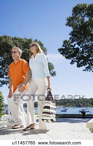 Couple with luggage walking up stairs (low angle view) View Large Photo Image Stock Photography - Couple with luggage walking up stairs (low angle view). Fotosearch