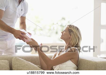 Stock Photo - Man giving present to woman. Fotosearch