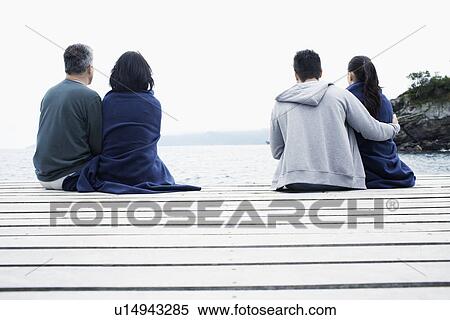 Mature and young couple on jetty View Large Photo Image Stock Photography - Mature and young couple on jetty. Fotosearch